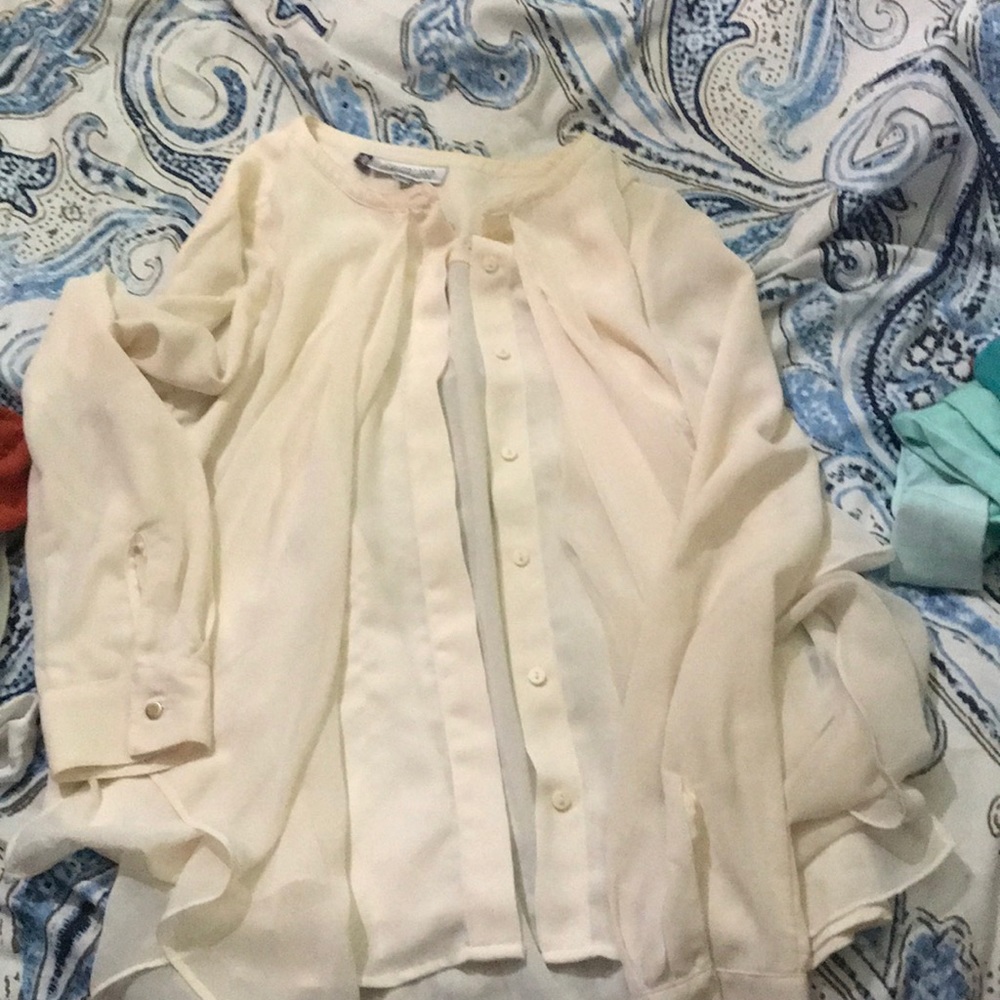 Cream colored button down blouse.
